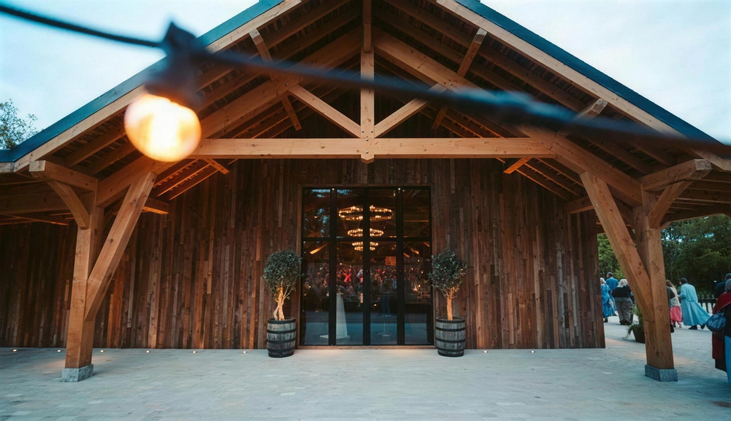 The Hideaway Barn lit at dusk with a wedding in full swing inside