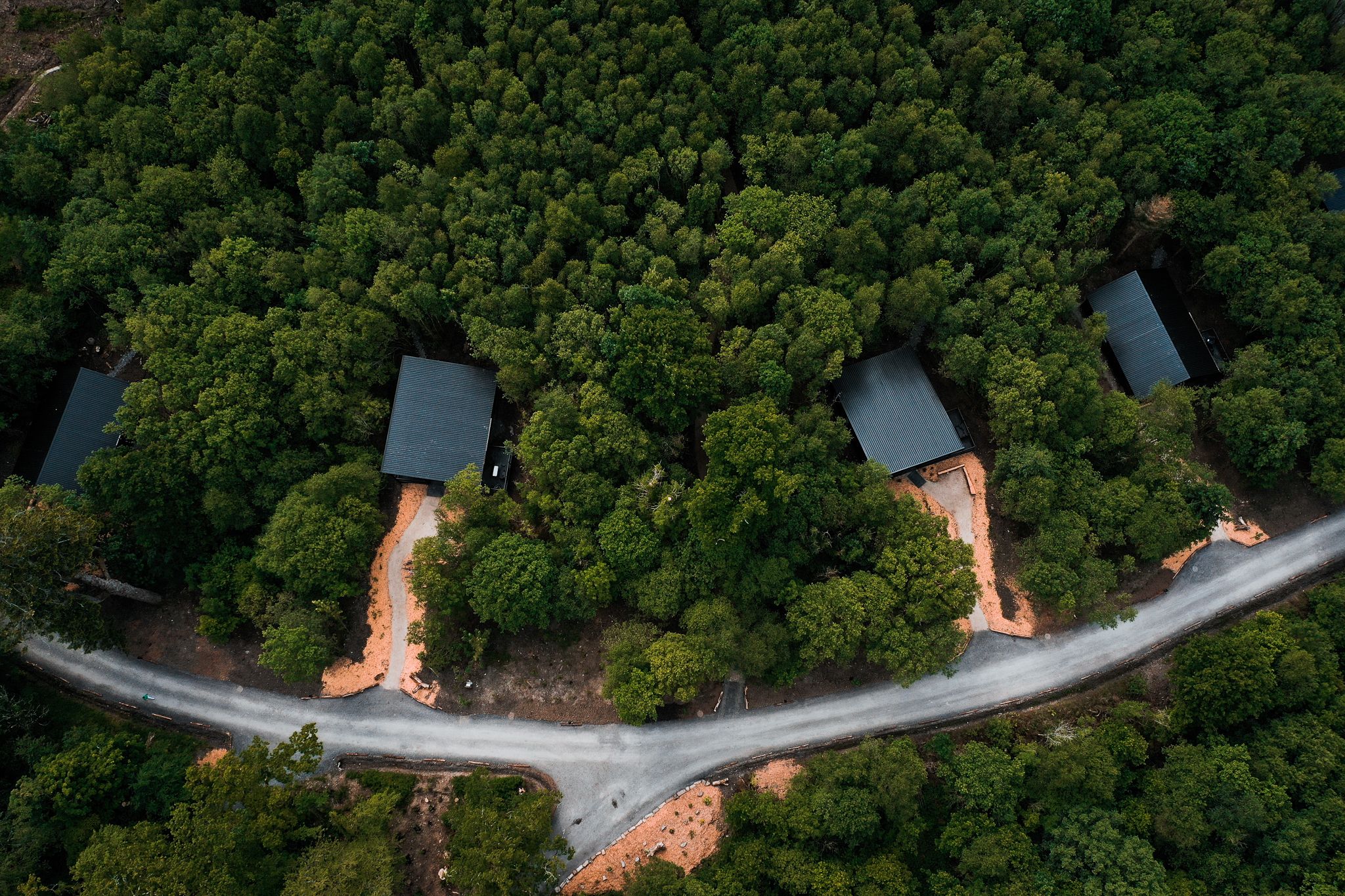Aerial over the whole estate and its lodges scattered through the woodland