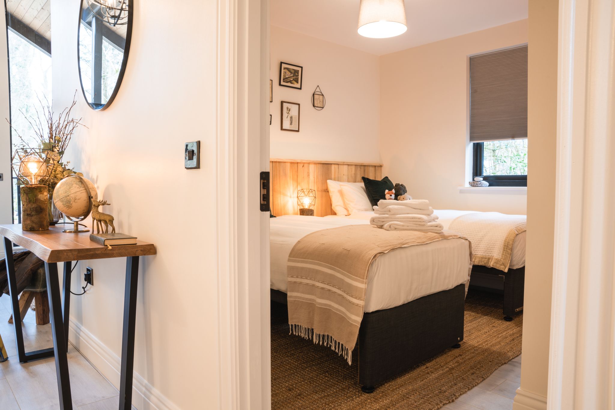 Bedroom with crisp white linen and a framed gallery wall