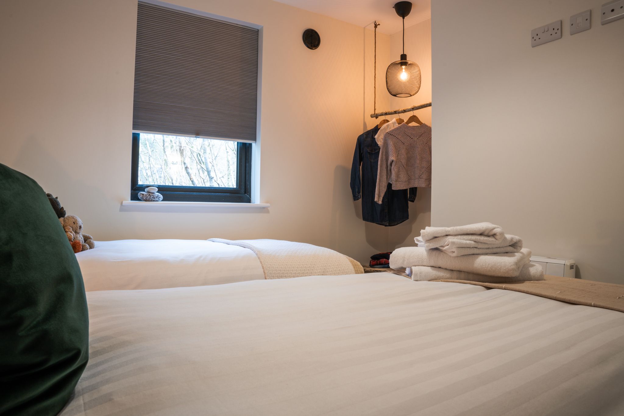 Bedroom made up with twin beds and folded towels
