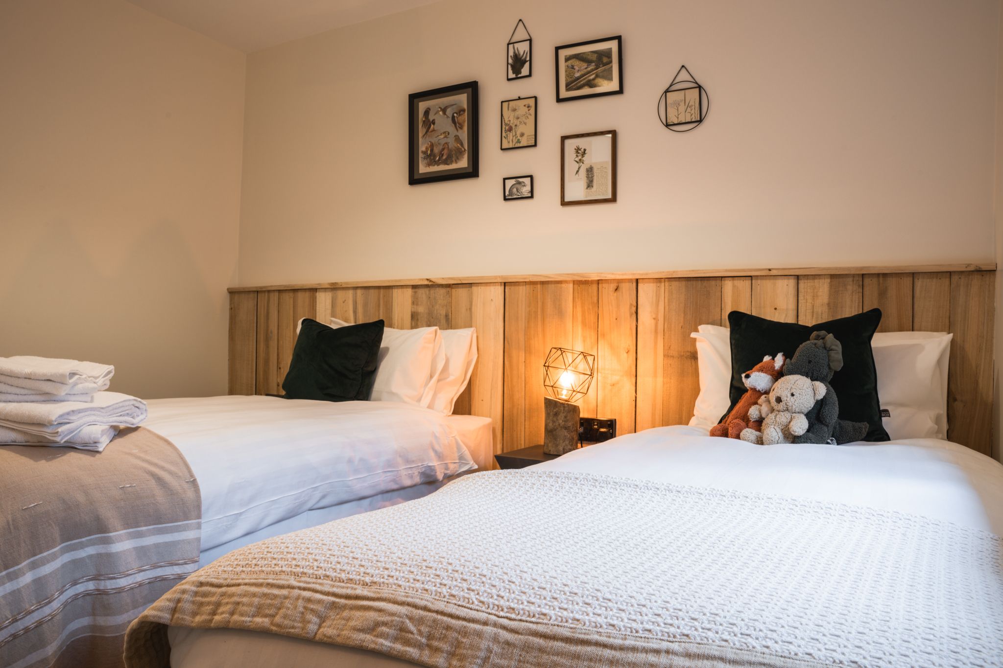 Bedroom with an estate-timber headboard and soft lamplight