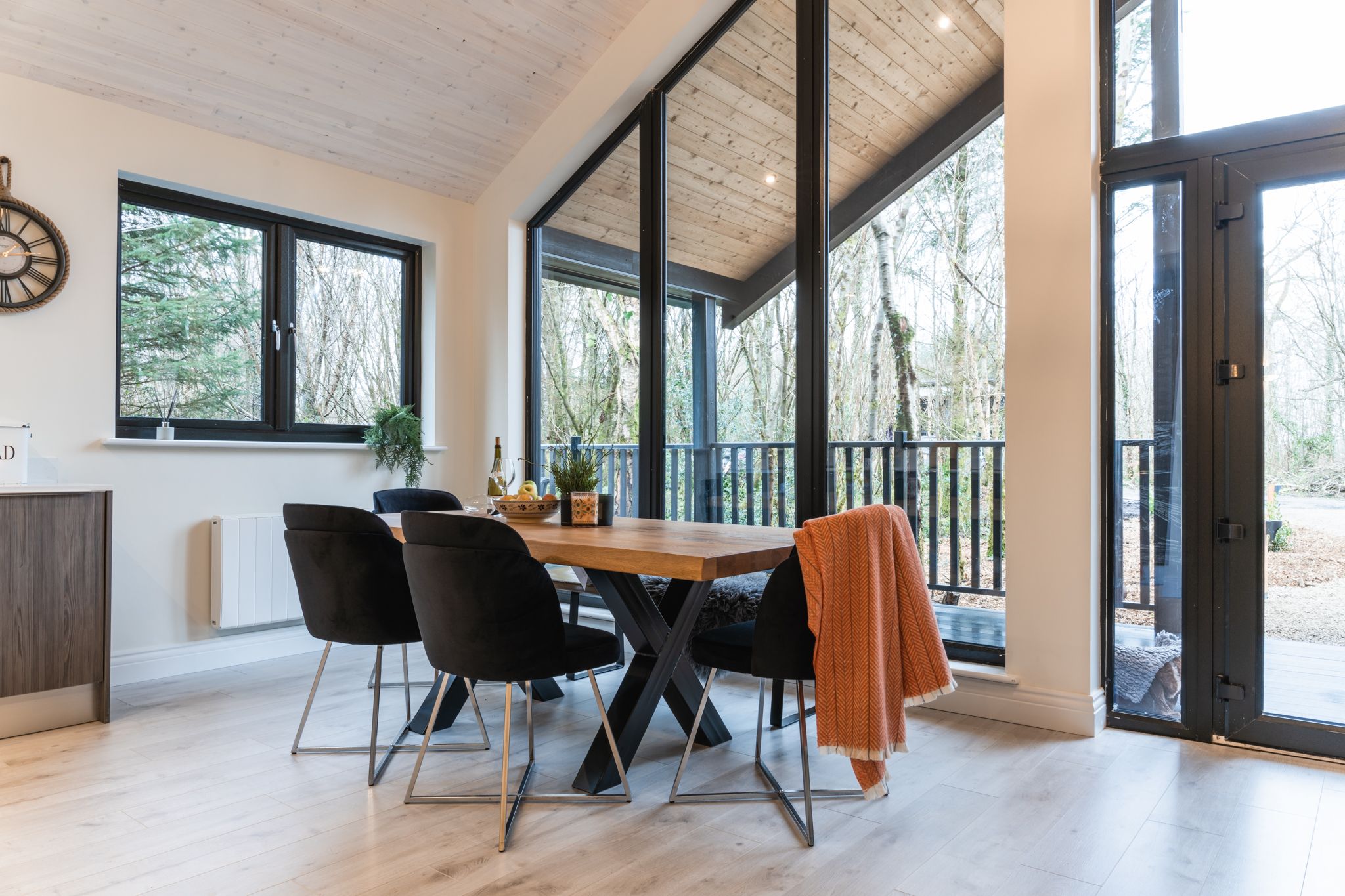 Dining table beside the glazed doors to the deck
