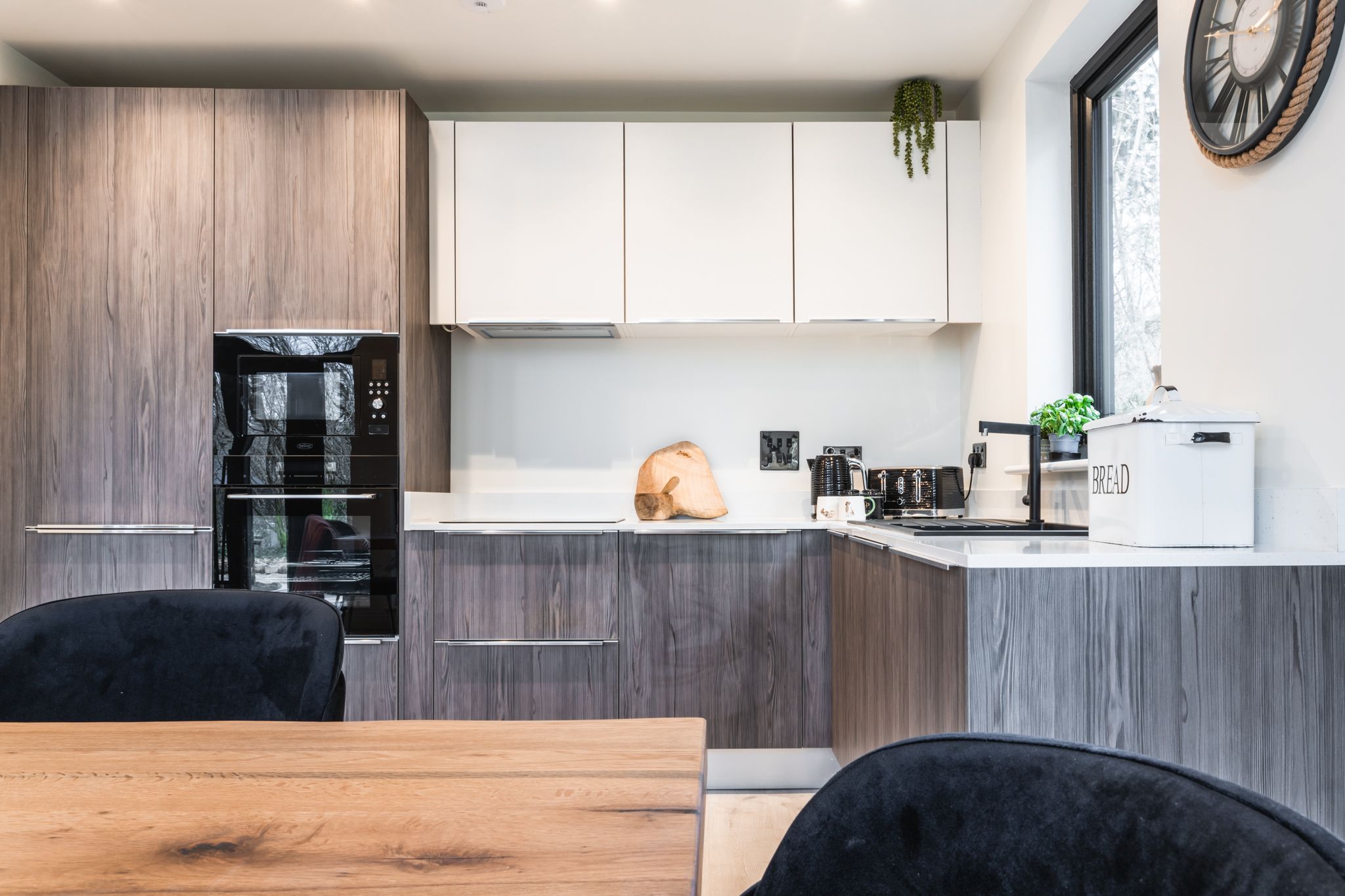 Open-plan kitchen with an island and woodland views