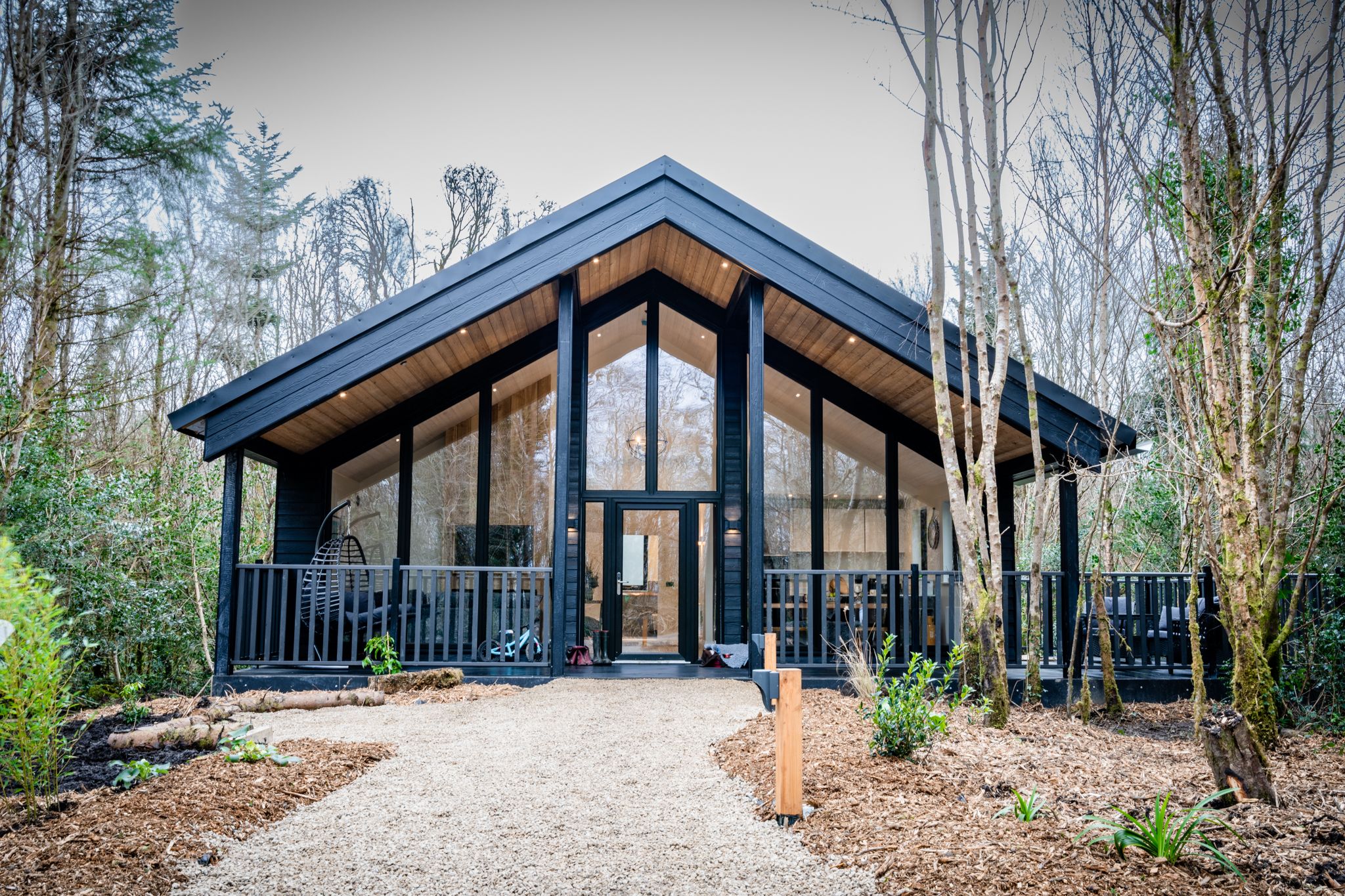 Contemporary lodge among the trees on the woodland path