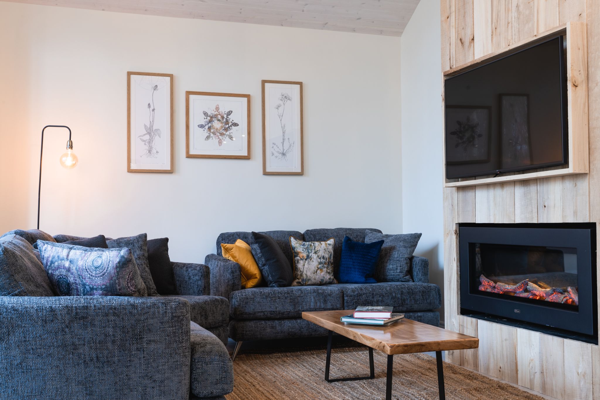 Living room with deep sofas and the fire lit
