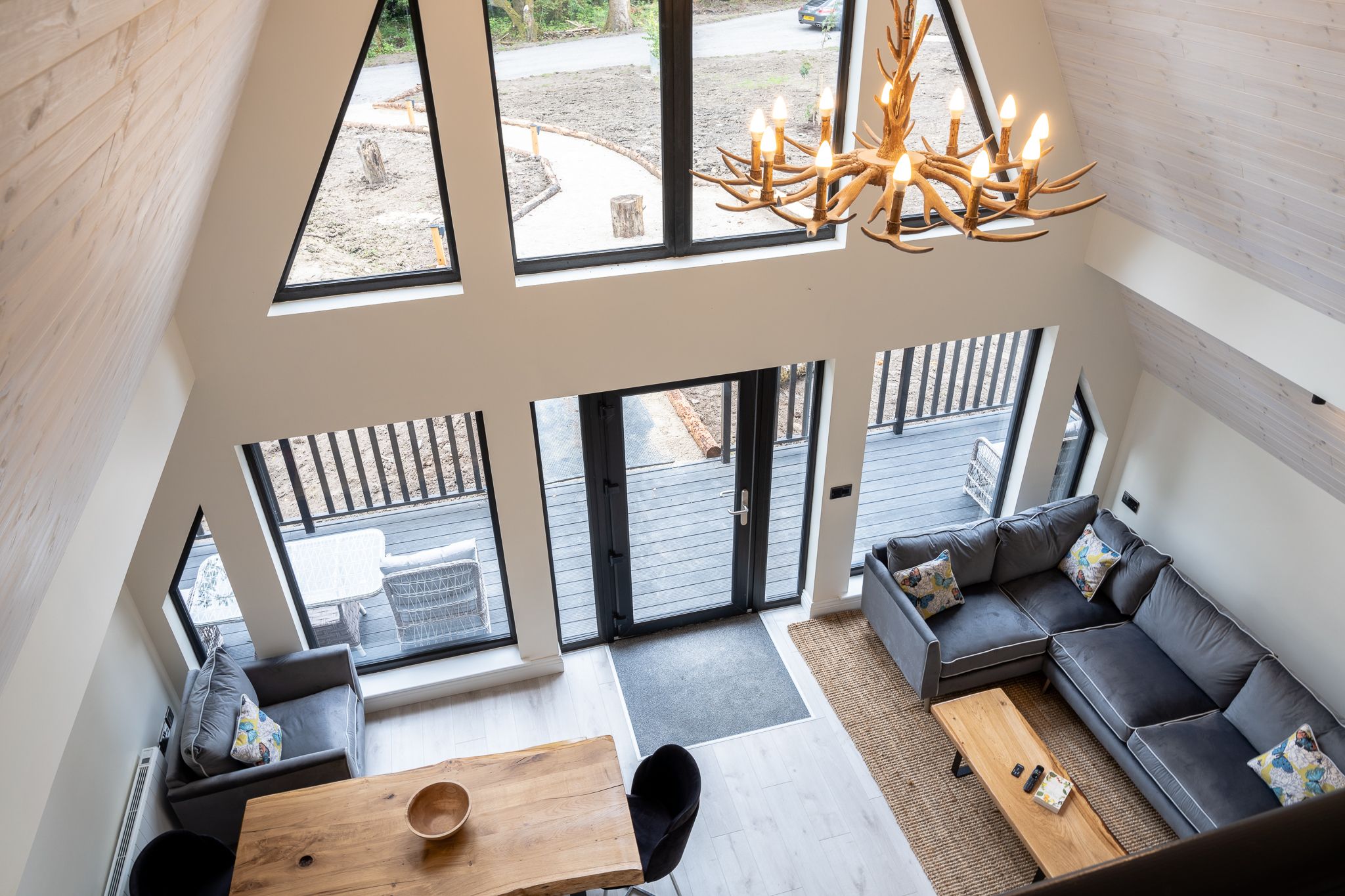 Loft mezzanine looking down over an A-frame living space