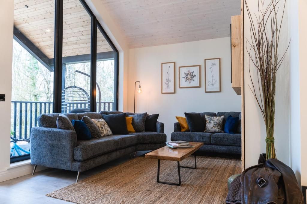 Open-plan living space with full-height glazing to the wood