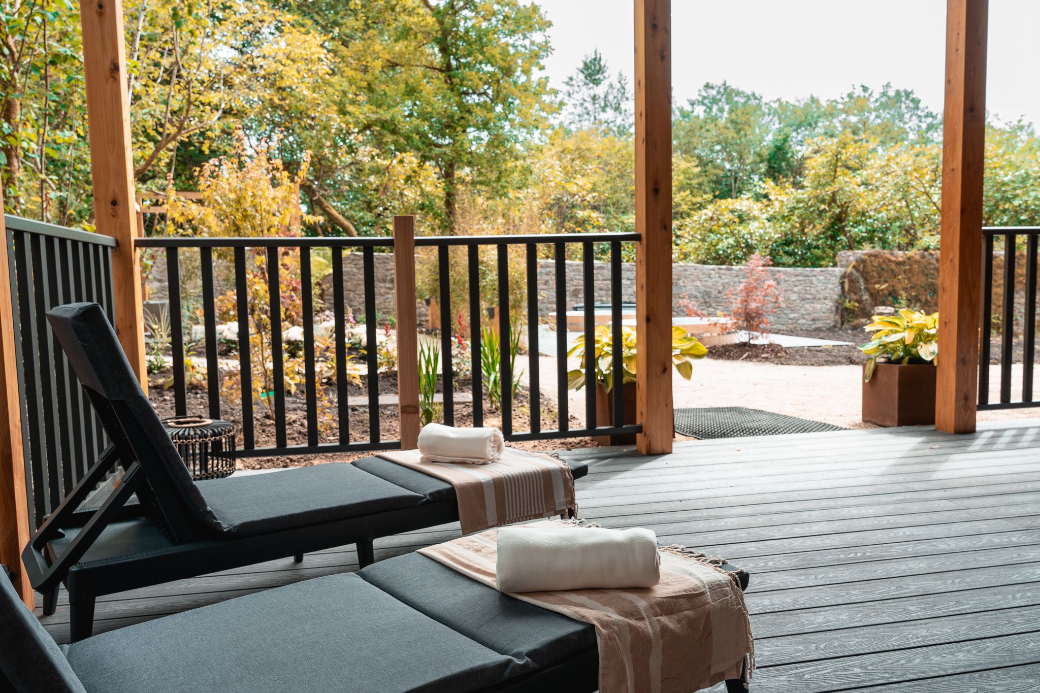 Loungers under the timber pavilion looking over the garden